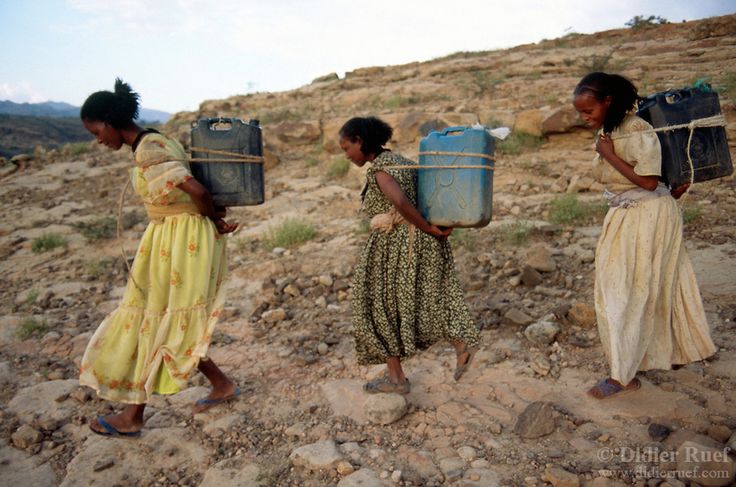 Eritrean girls carrying water in rocky highland