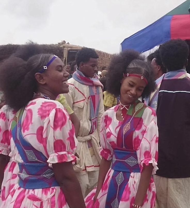 Eritrean tribal women in traditional striped dress with spears
